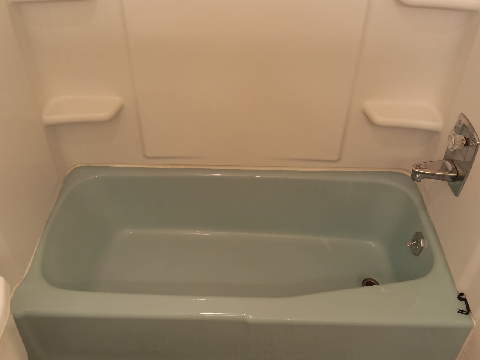 Worn green bathtub before refinishing